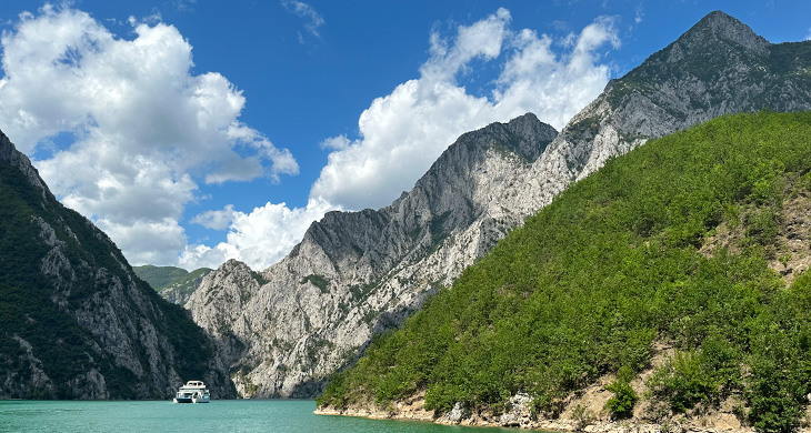 Boat on a lake surrounded by mountains