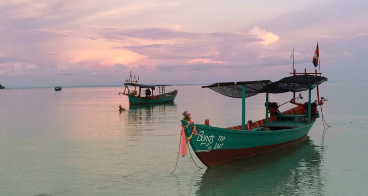 Boats on water in the sunset