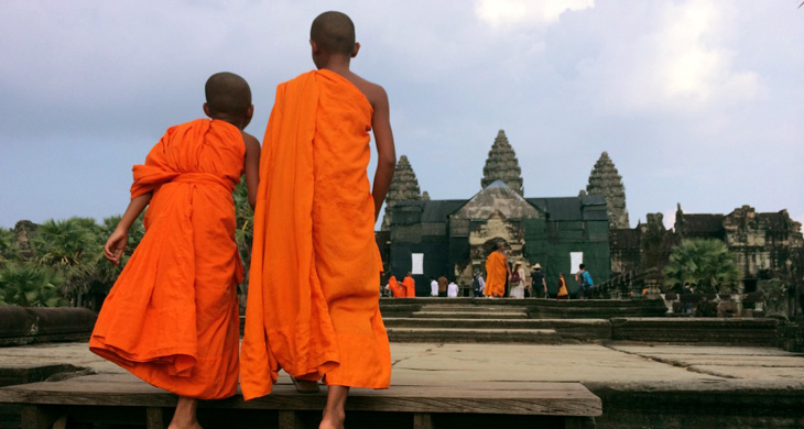 Two young munks walking towards Angkor Wat